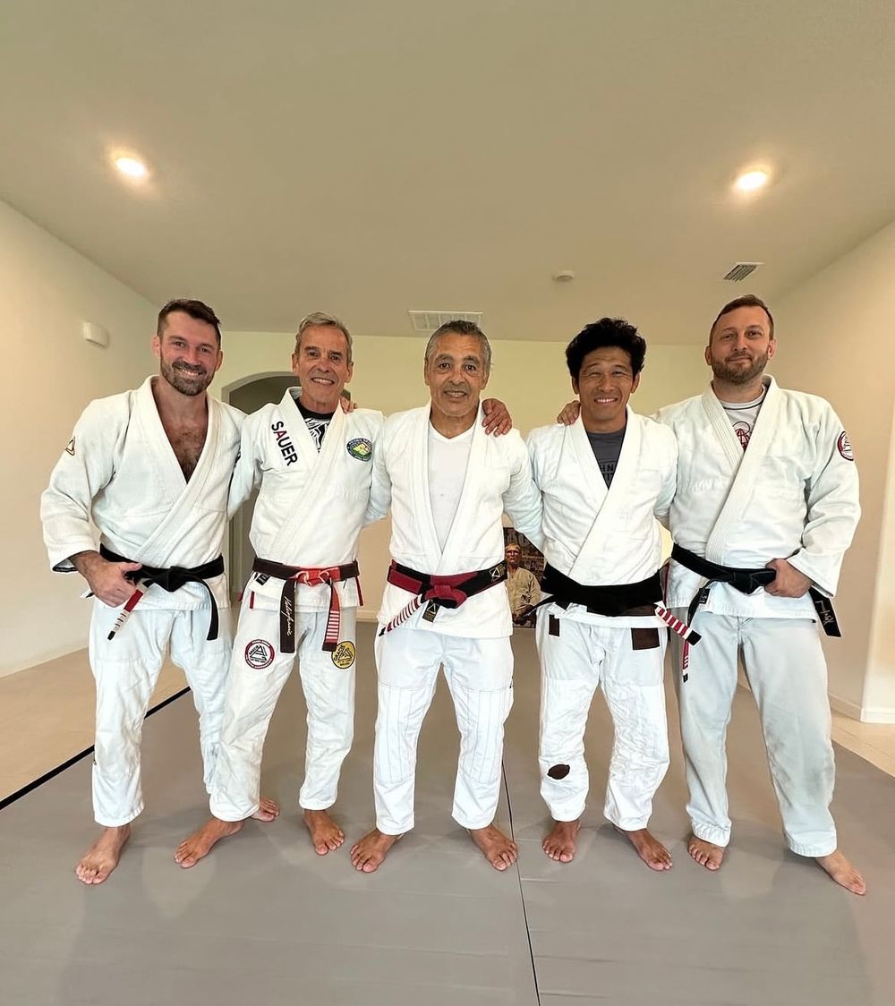James Driskill with Rickson Gracie and senior belts on a private mat